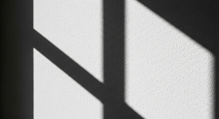 Poster - Abstract geometric shadow patterns cast on a textured white wall creating a stark contrast between light and dark