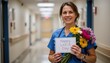 © Athiphat - portrait of smiling nurse holding flowers and a card that reads â€œhappy labor day