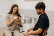 © Roman - Dentist showing teeth model to patient in dental clinic