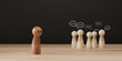 © Smile Studio AP - Sad wooden figure excluded from group. Concept of bullying, discrimination, isolation, loneliness, and mental health in society, workplace or school.