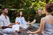 © Rido - Yoga class meditating in the middle of nature