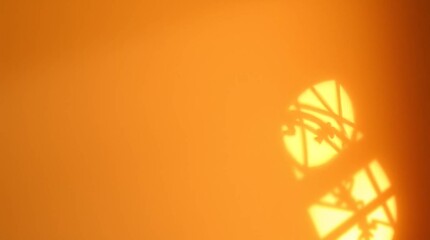 Aufkleber - Warm Sunlight Shadow: Abstract of sunlit architectural shadows casting intricate patterns against a warm orange wall, evoking feelings of serenity, warmth, and the passage of time.