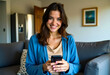 © Selim Aysolmaz - Portrait of a woman in a blue cardigan using her smartphone in a cozy modern living room — a lifestyle moment blending casual tech use with the warmth of home surroundings.