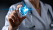 © Mrammon - A woman in a white lab coat holding a heart with a blue line around it