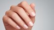 © Tanatchaporn - Close-up of a well-manicured hand with smooth skin and neatly trimmed nails.