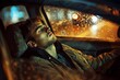 © juliars - Tired man sleeping in his car at night during rain with city lights in background