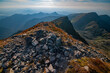 © AmazingAerialAgency - Aerial view of rocky ridges with sparse vegetation leading to distant, hazy peaks under a bright sky, JamnÃ­k, Å½ilina Region, Slovakia.
