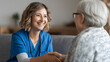 © Marius - Warm and Caring Nurse Interacting with Elderly Woman in Comfortable Medical Environment Smiling Together