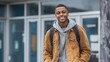 © Mimi - Smiling Black Teen Student with Backpack Standing Confidently Outside Modern School Building
