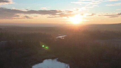 Wall Mural - xa drone aerial view over sunrise on a foggy morning is highly atmospheric and cinematic, perfect fo