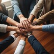 © Vanilazas - Top View of Hands Stacked Together as Symbol of Teamwork and Unity