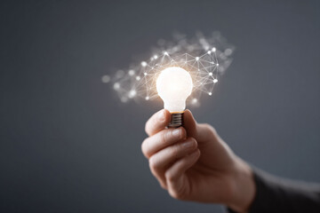 Poster - Hand holding a bright light bulb surrounded by a network, symbolizing ideas, innovation, and connectivity. Perfect for tech, education, or business concepts.