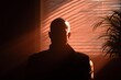 © P - Anonymous tech whistleblower interviewed in a dark room with venetian blind shadows, creating a mysterious and dramatic investigative documentary atmosphere.