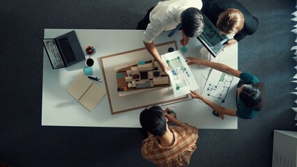 Poster - Top down view of manager pointing at house model and explain building design. Aerial view of architect engineer brainstorming about interior construction while tablet display house plan. Alimentation.