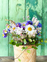 Wall Mural - Beautiful bouquet of wild flowers in a basket - floral summer greeting card - Happy Birthday 