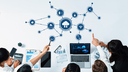 Poster - A group of professionals engages in a collaborative session on cloud computing, utilizing laptops and charts to highlight digital transformation and strategic insights. Amity