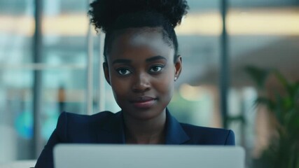 Aufkleber - A person sitting in front of a laptop with a focused expression, possibly working or studying