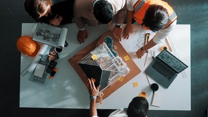 Poster - Top down aerial view of smart architect engineer team inspect house model while manager hold blueprint and asking about building construction. Group of diverse engineer working together. Alimentation.