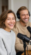 © Sergey - Podcast co-hosts laughing during a show recording session in studio
