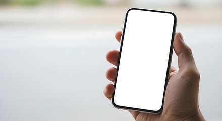 Poster - A hand holding a smartphone with a blank white screen against a blurred background in a studio shot