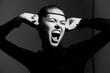 © SHOTPRIME STUDIO - Emotional young woman expressing frustration with hands on her head, wearing a black outfit and fishnet headpiece. Black and white artistic portrait.