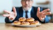 © VirtuLens - Businessman showcasing perfect donuts on a plate with a hand gesture