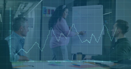 Poster - Standing woman in pink sweater presenting at flipchart in office meeting room, with marker, papers