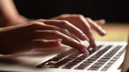 Poster - Close Up of Woman Hands Typing on Laptop Keyboard in Dim Lighting Focused on Fingers and Keys
