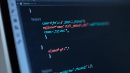 Poster - Computer Screen Displaying Brightly Colored Code Close up on a Dark Background For Software and Technology