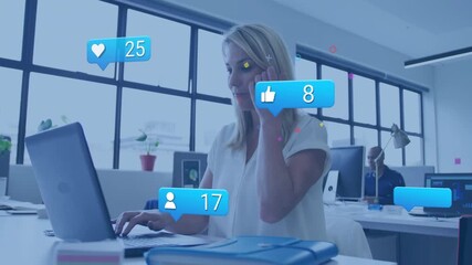 Poster - Mature woman typing at office desk and monitoring animated social media icons rising above laptop