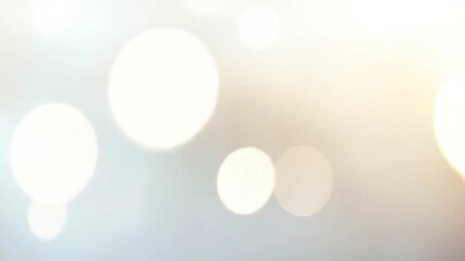 Wall Mural - A soft, minimalistic background with warm white bokeh lights gently drifting and fading in and out. Subtle light orbs move slowly across a bright, airy backdrop, like sunlight filtering through mist.