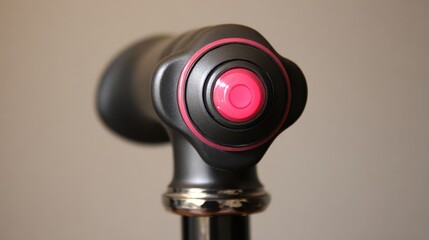 Poster - Close-up view of a dark gray device knob with a bright pink accent.
