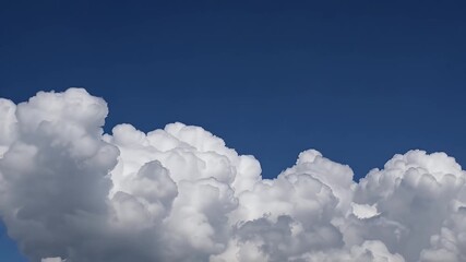 Wall Mural - magnificent cumulonimbus clouds surge skyward in time lapse motion revealing immense vertical towers of white and gray that gradually part to unveil brilliant blue skies evoking the drama of