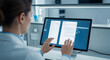 © Hendriawan - Scientist Reviewing Digital Documents on Computer Screen.