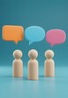 © Jim - Three wooden figures stand beneath vibrant speech bubbles a blue backdrop, communication, ideas, collaborative discussions. 3D render of three wooden figures standing in front of a blue wall