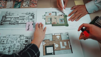 Poster - A pair of hands examining architectural blueprints and interior design plans on a workspace. Colorful samples and materials surround detailed layouts, showcasing the design process. SACTR