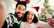 © peopleimages.com - Happy, couple and selfie for Christmas in home, memory and celebration for December holiday or love. Bonding, man and woman with smile for profile picture POV, festive season and photography in house