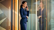 © Ksenplus - Professional Asian woman talking on the phone in modern office