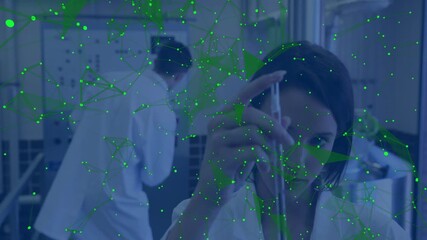 Poster - Researcher grabbing pipette while colleague adjusting instrument with network overlay for research