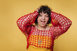 © bodnarphoto - Woman expresses joy and excitement while wearing colorful outfit against a vibrant yellow background