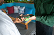 © lordn - Close-up of a person making a mobile payment using a smartphone and wireless card reader in a modern indoor setting