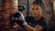 © Tinnaphat - Determined boxer training in gym focused workout session indoor environment close-up view empowerment concept