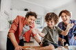 © Marko Geber - Young caucasian family being messy and having fun baking together in the kitchen