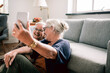 © Davor - Senior women taking a happy selfie together at home