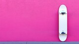 White skateboard leaning against a vibrant pink wall. (3)