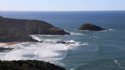 Wall Mural - Beautiful view of beach coastline with green hills.