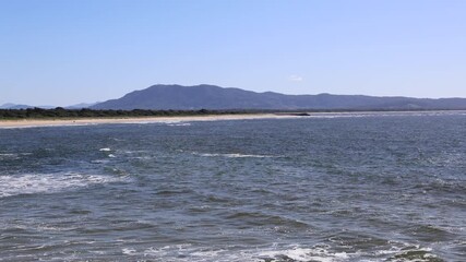 Wall Mural - Beautiful view of hill and beach on a sunny day.