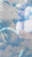 Poster - Animation of network of connections and sky with clouds over african american man using smartphone