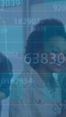 Poster - Animation of financial data processing on diverse man and woman smiling looking at laptop at office