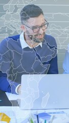 Poster - World map animation over diverse business team collaborating at desk